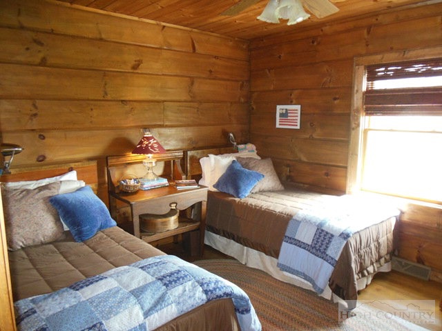 1242 Lazy Branch Road Ennice, NC 28623 - Photo 23 of 29 a bedroom with a bed and wooden floor