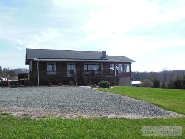 1242 Lazy Branch Road Ennice, NC 28623 - Photo 9 of 29 a front view of a house with garden