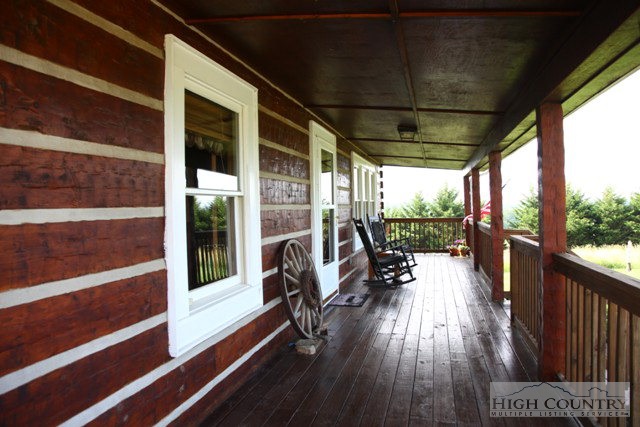 1242 Lazy Branch Road Ennice, NC 28623 - Photo 10 of 29 a view of a balcony with chairs and wooden floor