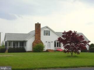 35205 Poplar Neck Road Pittsville, MD 21850 - Photo 1 of 12 a front view of house with yard and green space