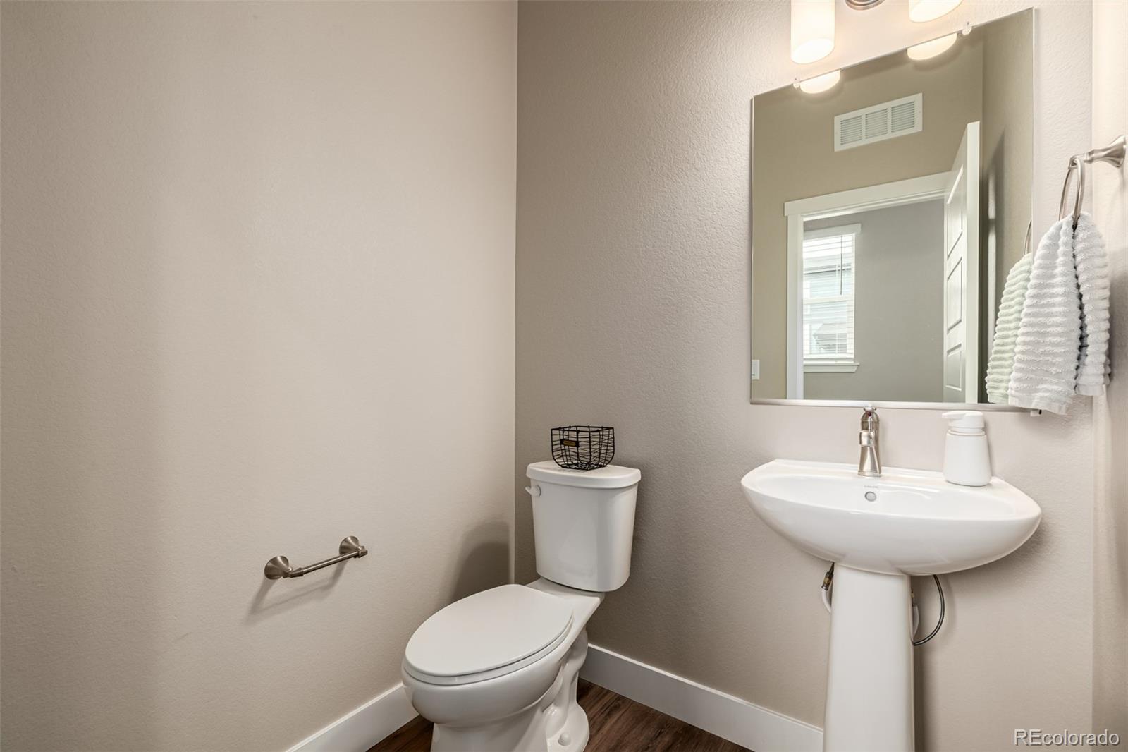 1575 West 68th Avenue Denver, CO 80221 - Photo 13 of 39 a bathroom with a toilet sink and mirror