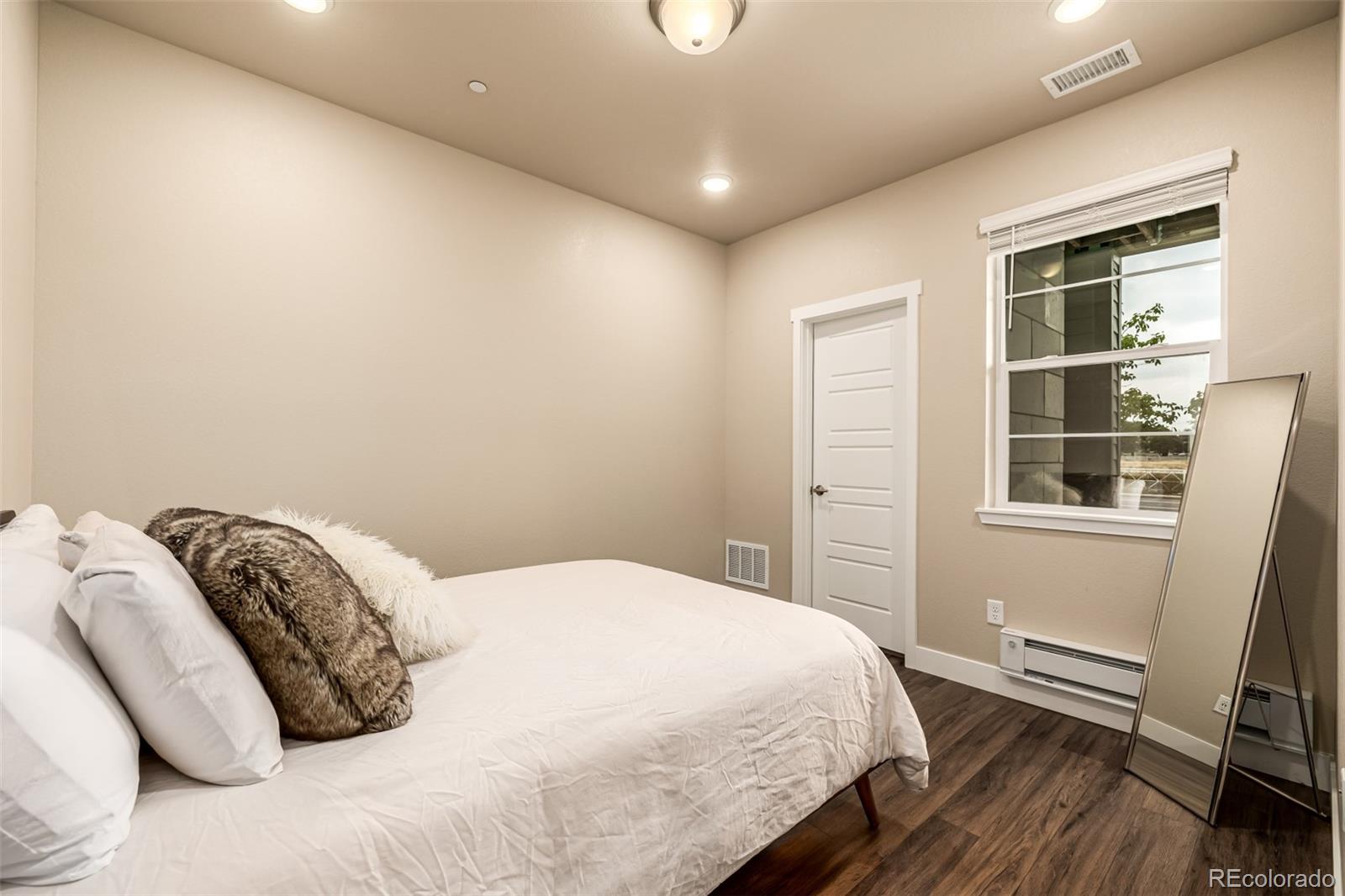 1575 West 68th Avenue Denver, CO 80221 - Photo 19 of 39 a bedroom with a bed and a window