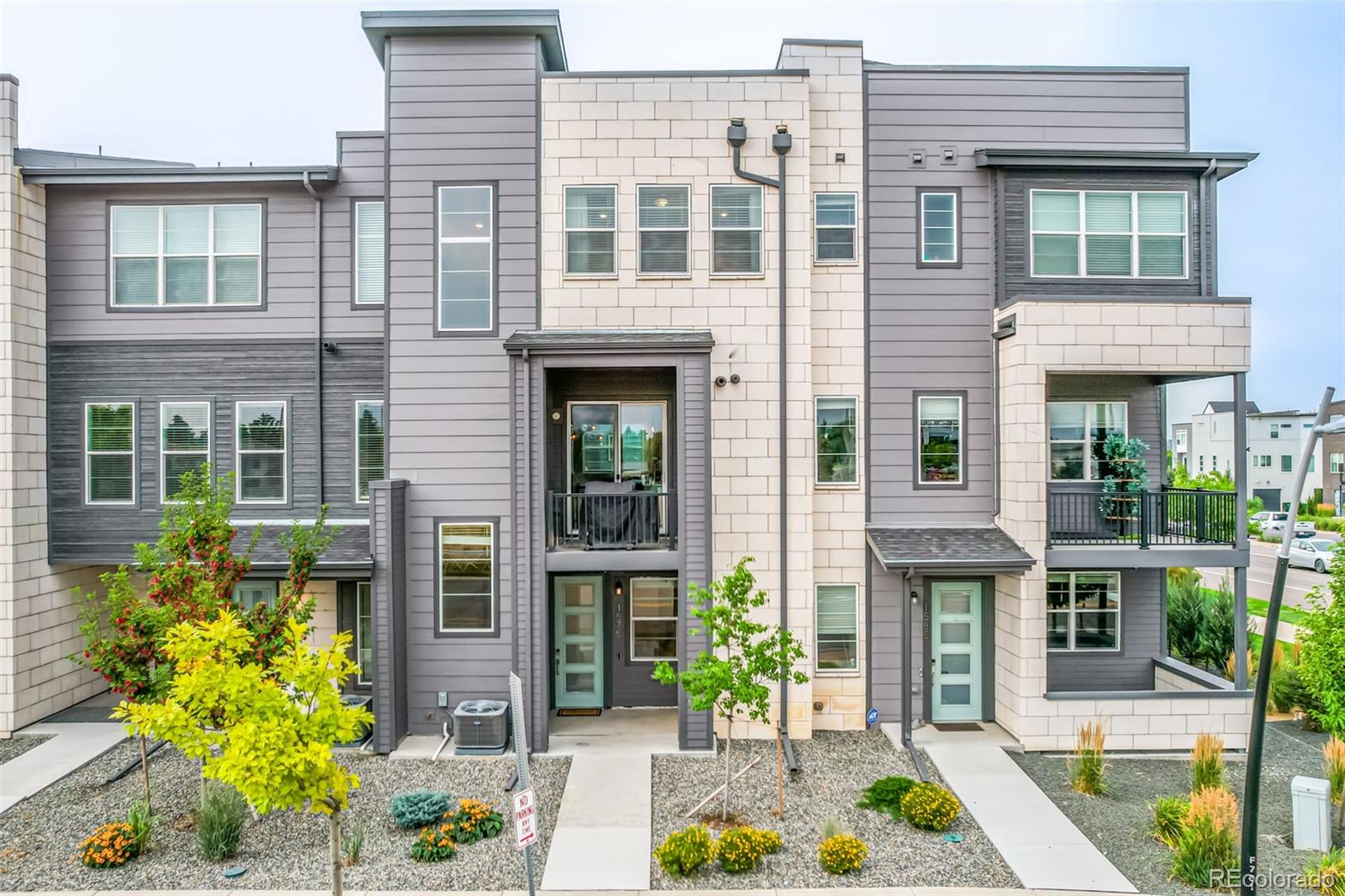 1575 West 68th Avenue Denver, CO 80221 - Photo 36 of 39 front view of a brick house with a large window and a potted plant