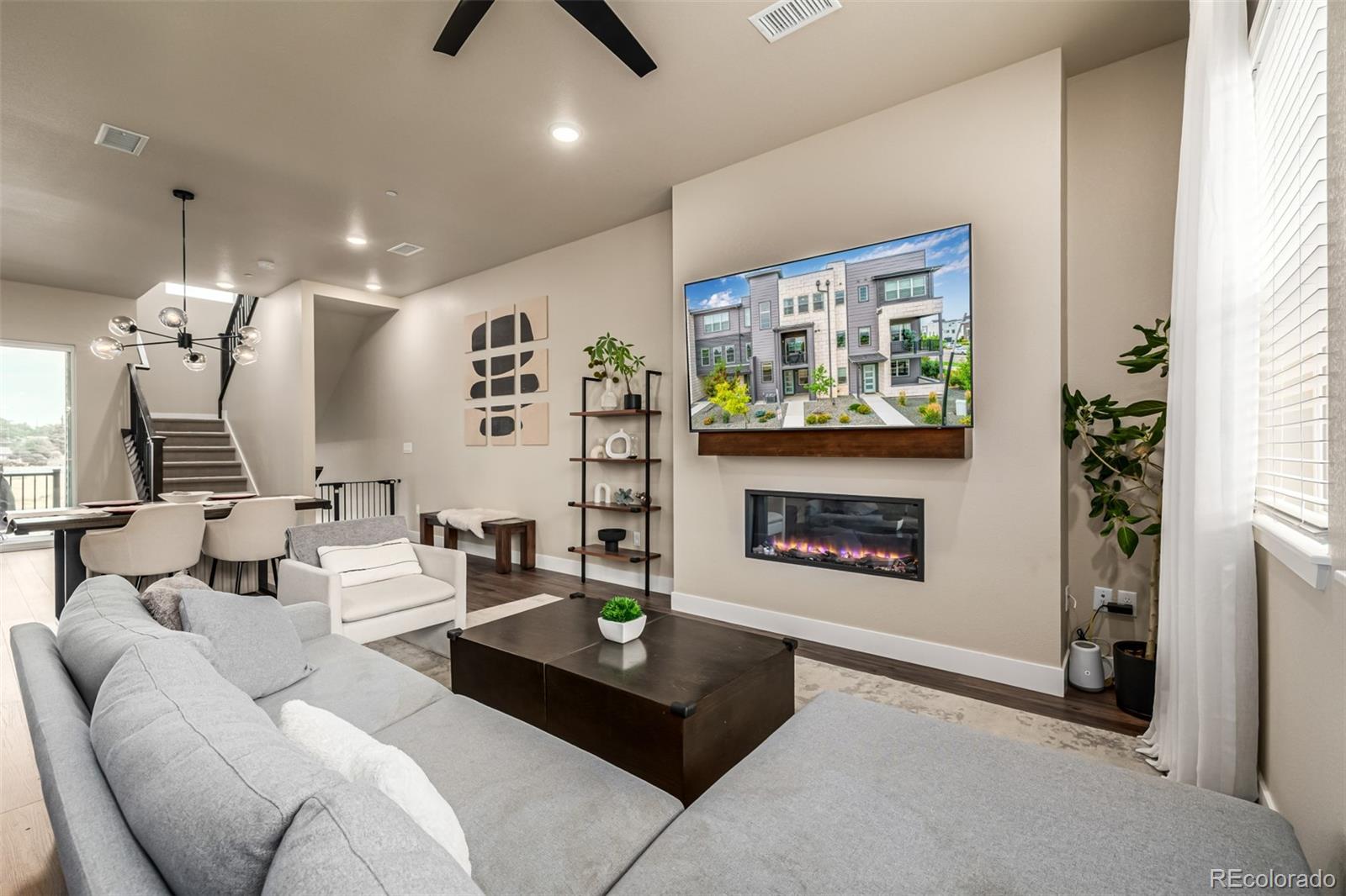 1575 West 68th Avenue Denver, CO 80221 - Photo 5 of 39 a living room with furniture a fireplace and a large window