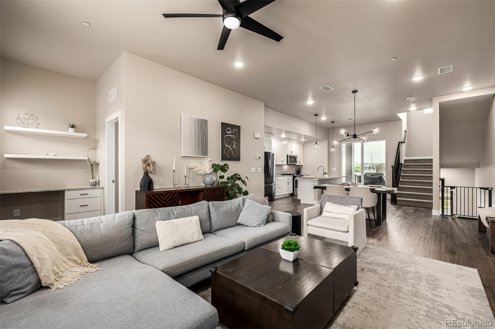 1575 West 68th Avenue Denver, CO 80221 - Photo 6 of 39 a living room with furniture kitchen view and a chandelier