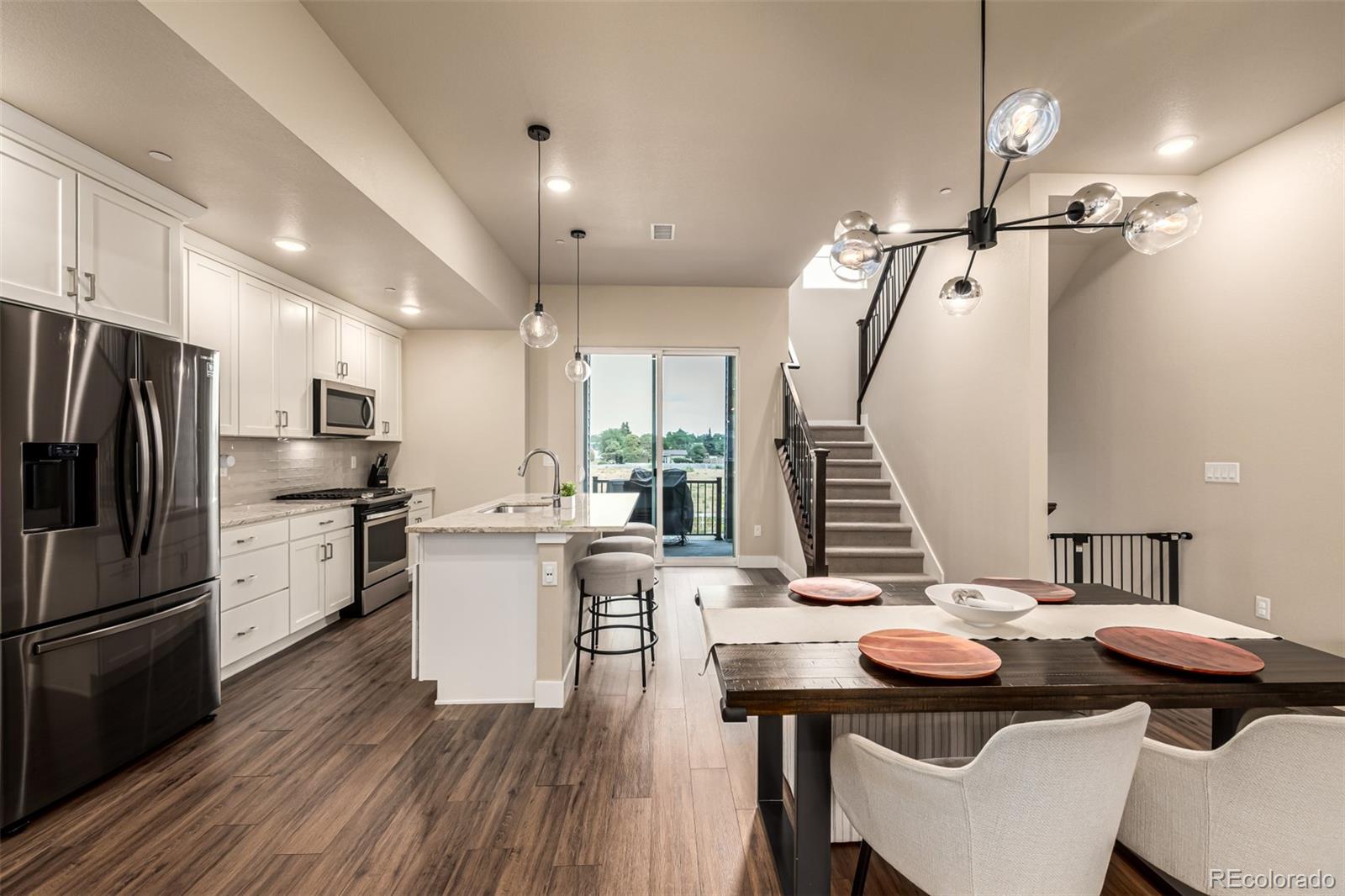 1575 West 68th Avenue Denver, CO 80221 - Photo 7 of 39 a kitchen with refrigerator and wooden floor