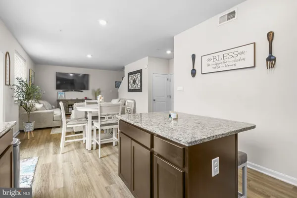 a view of a kitchen with a dining table chairs and couches