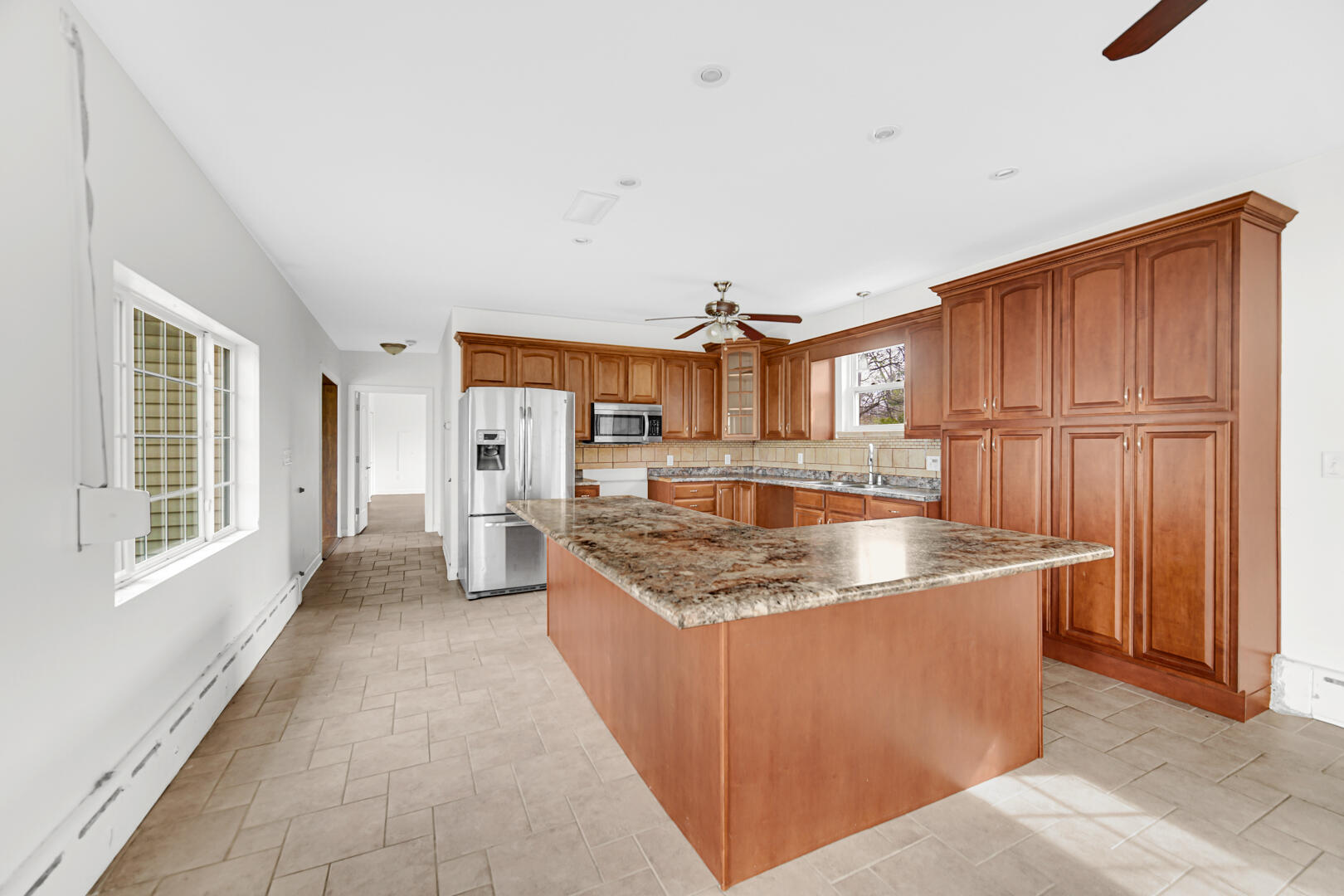 3721 West 133rd Avenue Crown Point, IN 46307 - Photo 14 of 30 a kitchen with stainless steel appliances granite countertop a sink a stove and a refrigerator