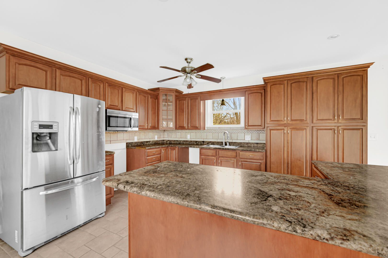 3721 West 133rd Avenue Crown Point, IN 46307 - Photo 16 of 30 a kitchen with stainless steel appliances granite countertop a refrigerator a stove and a sink with granite countertops
