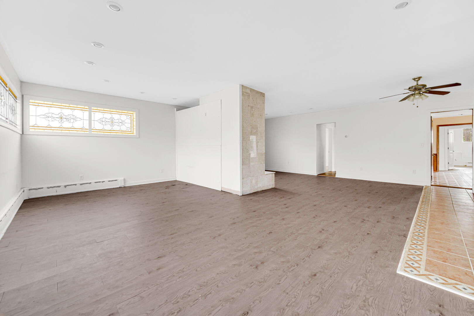 3721 West 133rd Avenue Crown Point, IN 46307 - Photo 2 of 30 an empty room with a chandelier fan and windows