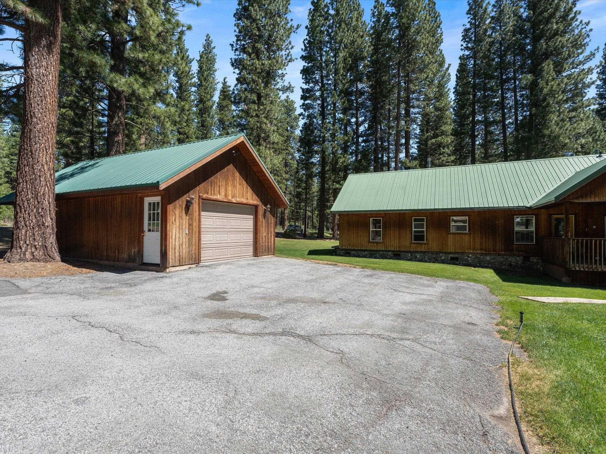 97 Main Street Calpine, CA 96124 - Photo 9 of 43 a front view of a house with a yard and garage