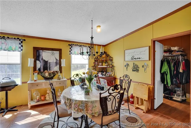 a view of a dining room with furniture and chandelier