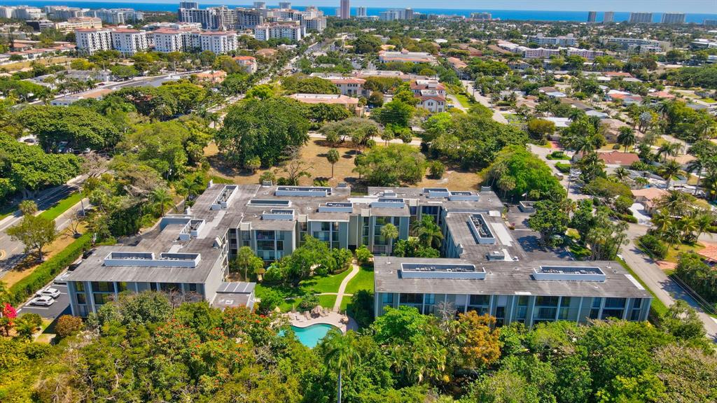 an aerial view of multiple houses with a yard