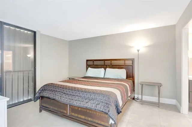 a bedroom with a bed and a night stand