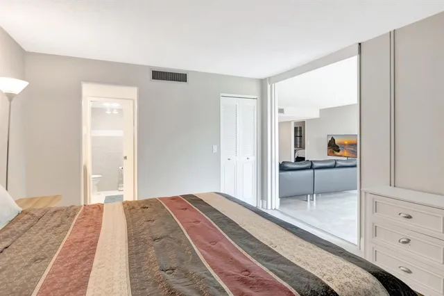 a bedroom with a bed and a mirror