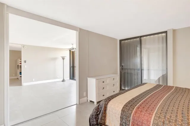 a bedroom with a bed and a mirror