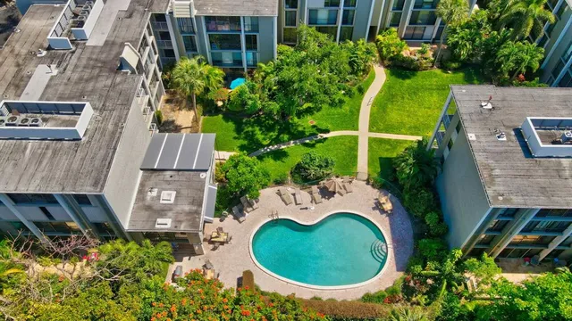 an aerial view of a house with garden space and swimming pool