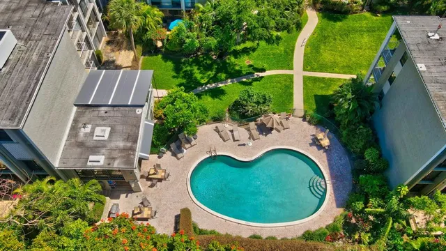 an aerial view of a house with a yard and swimming pool