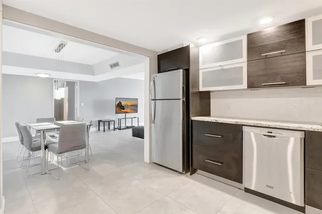 a kitchen with a refrigerator and a sink