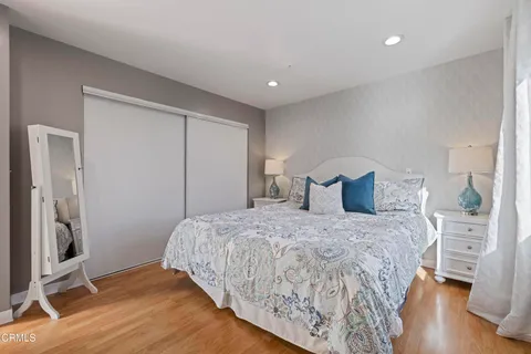 a spacious bedroom with a bed and a view of bedroom
