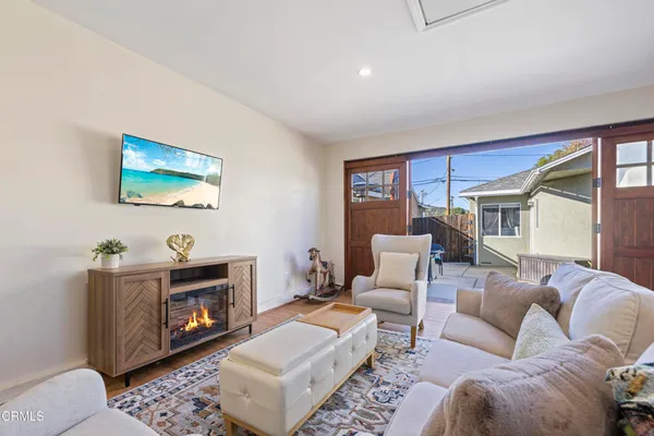 a living room with furniture a rug and a fireplace