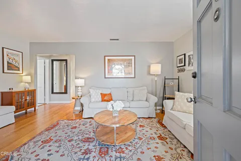 a living room with furniture and a rug