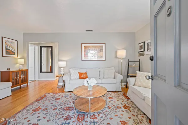 a living room with furniture and a rug