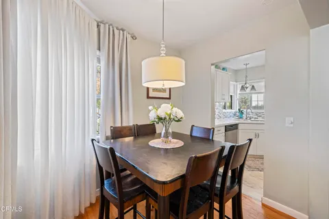 a dining room with furniture and wooden floor