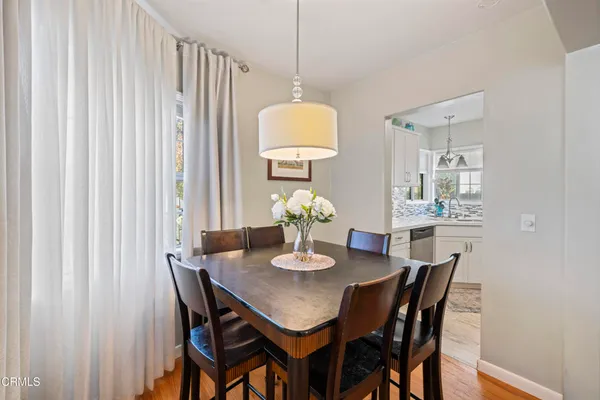 a dining room with furniture and wooden floor