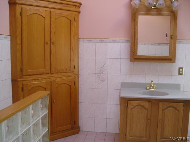 447 Ward Road North Tonawanda, NY 14120 - Photo 12 of 12 Bathroom Beautiful tiled bath with oak vanity and