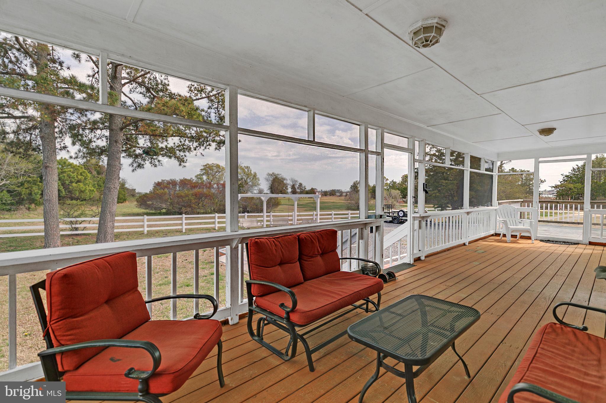 1887 Point Breeze Road Hudgins, VA 23076 - Photo 66 of 77 a living room with furniture a large window and a chandelier