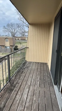a view of a balcony with wooden floor