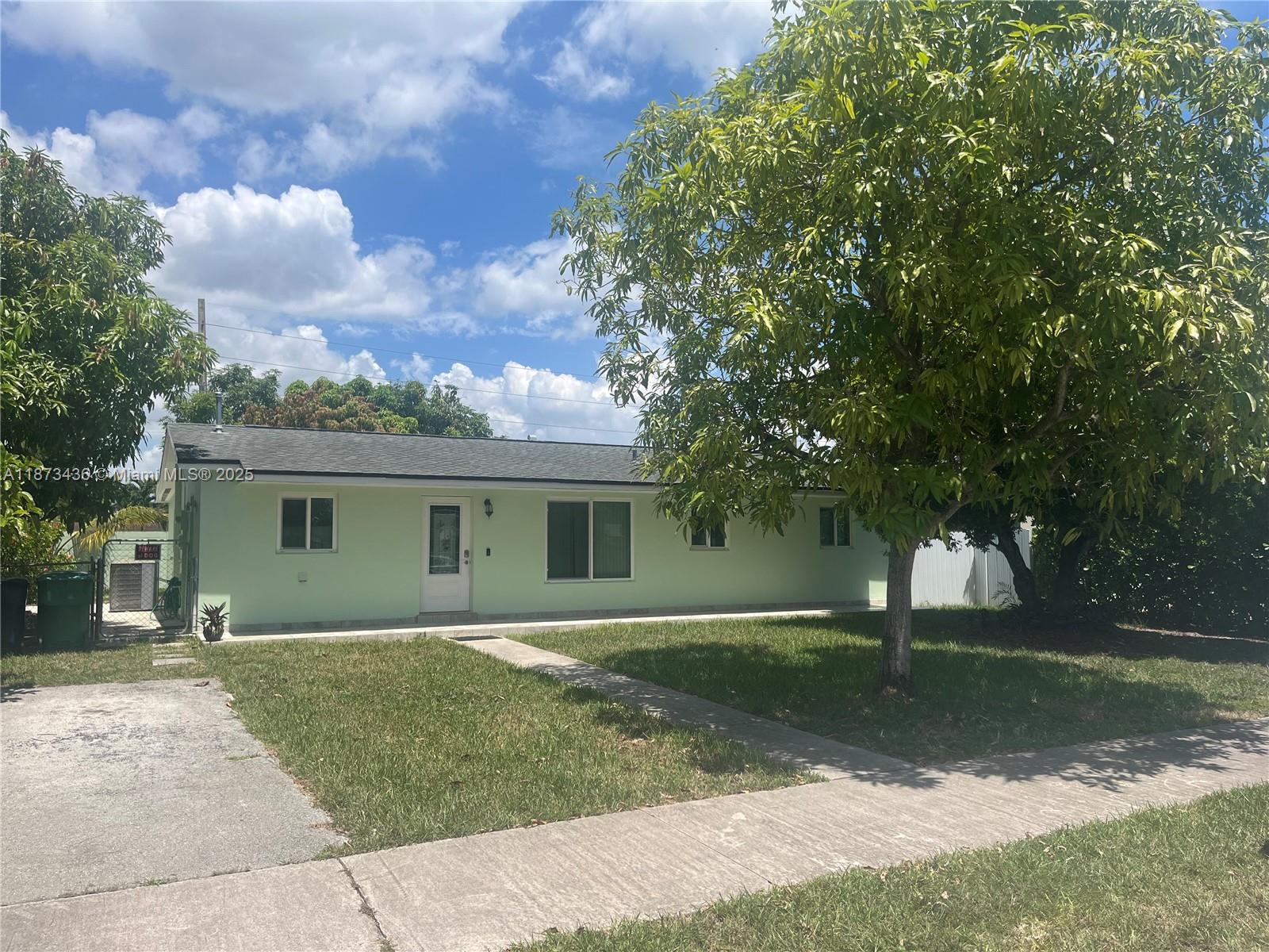 10315 Southwest 152nd Terrace Miami, FL 33157 - Photo 1 of 12 front view of a house with a yard