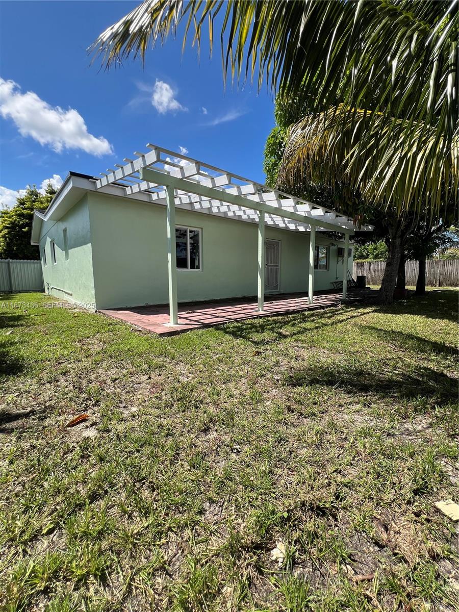10315 Southwest 152nd Terrace Miami, FL 33157 - Photo 12 of 12 a view of a house with a yard