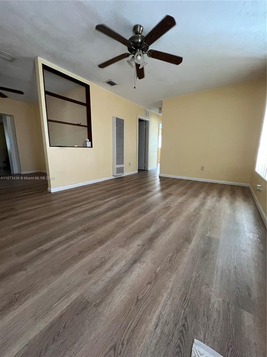 10315 Southwest 152nd Terrace Miami, FL 33157 - Photo 2 of 12 wooden floor in an empty room with a window