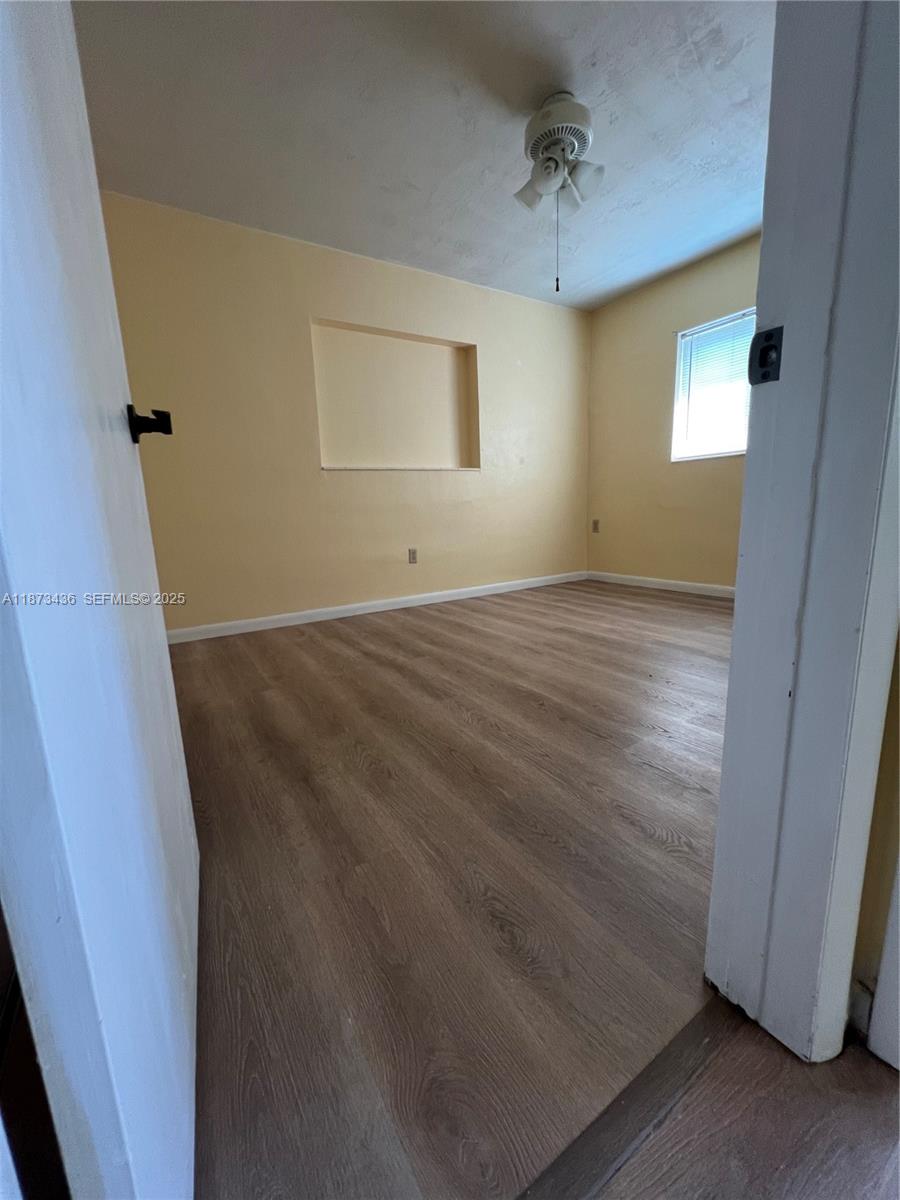 10315 Southwest 152nd Terrace Miami, FL 33157 - Photo 6 of 12 an empty room with windows and cabinet