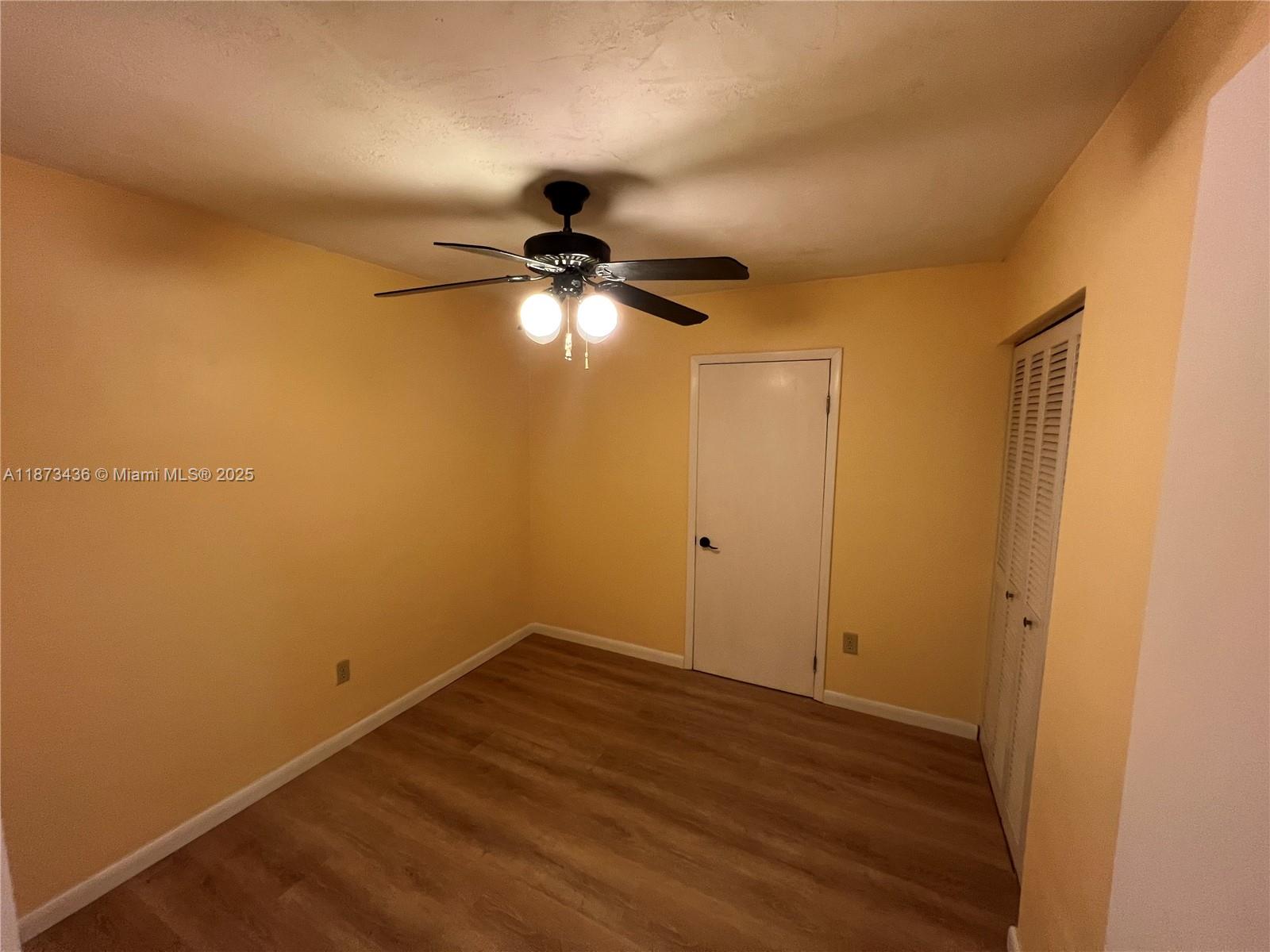 10315 Southwest 152nd Terrace Miami, FL 33157 - Photo 7 of 12 a view of empty room with wooden floor