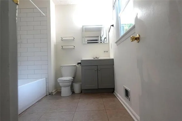 a bathroom with a toilet a sink and bathtub