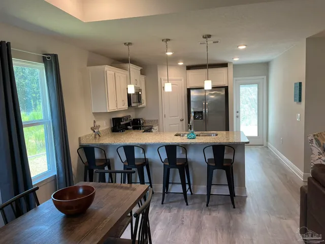 a view of a dining room with furniture and wooden floor