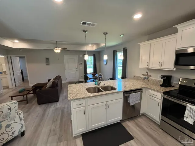 a kitchen with a sink stove and cabinets