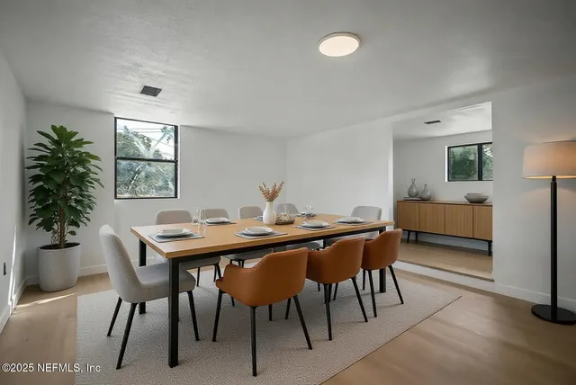 a bedroom with a bed lamps and a large window