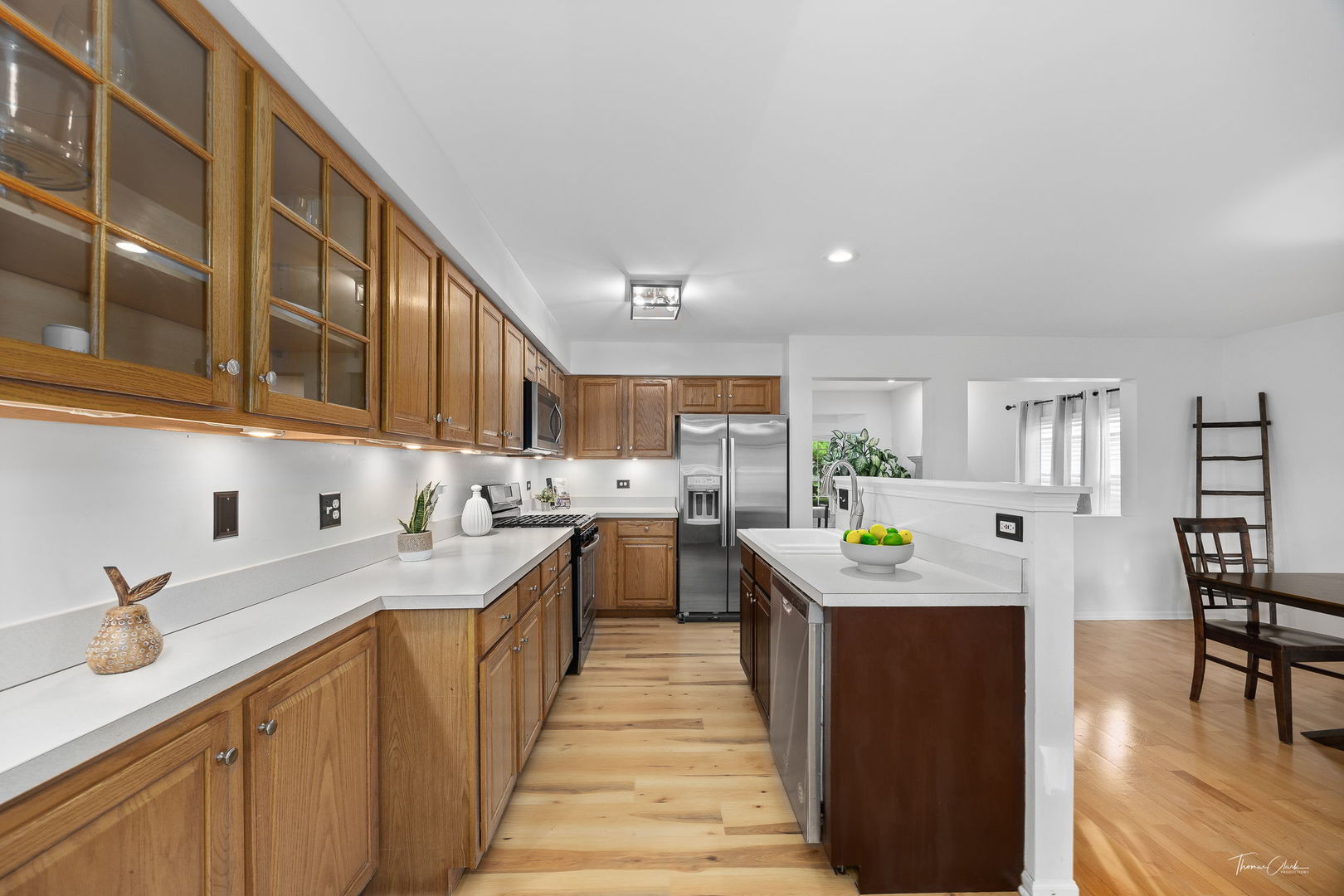 1910 Baldwin Way Bolingbrook, IL 60490 - Photo 13 of 38 a kitchen that has a lot of cabinets in it and wooden floors