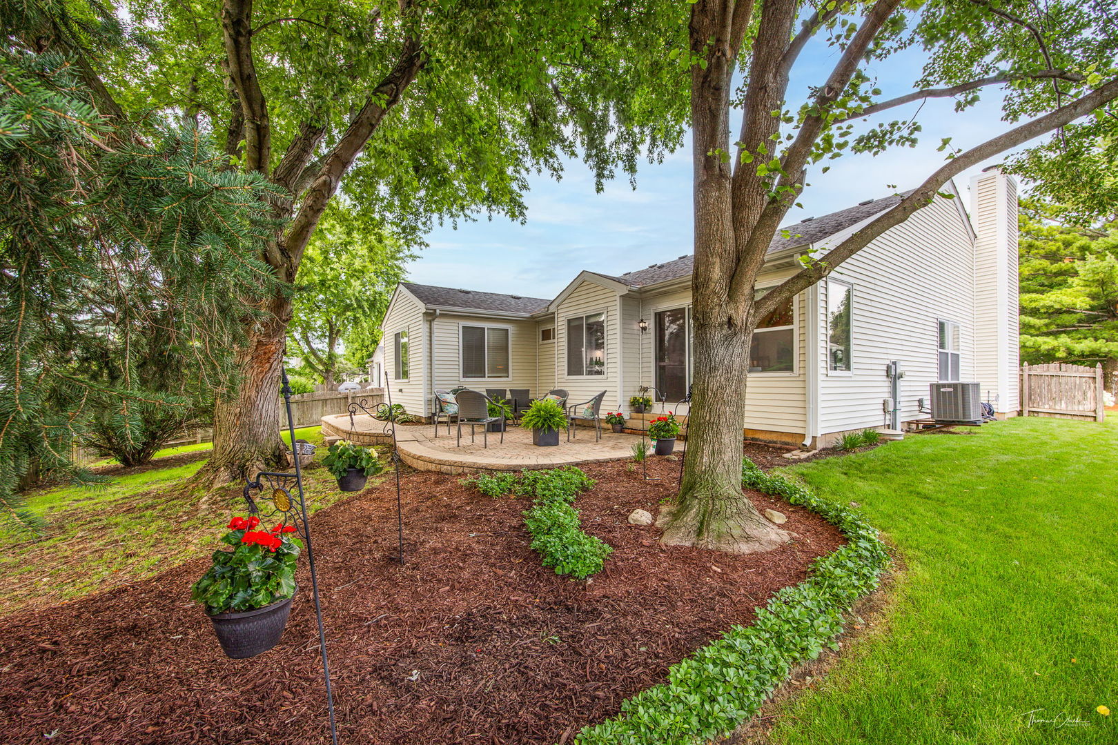 1910 Baldwin Way Bolingbrook, IL 60490 - Photo 31 of 38 a view of a patio with couches plants and large trees