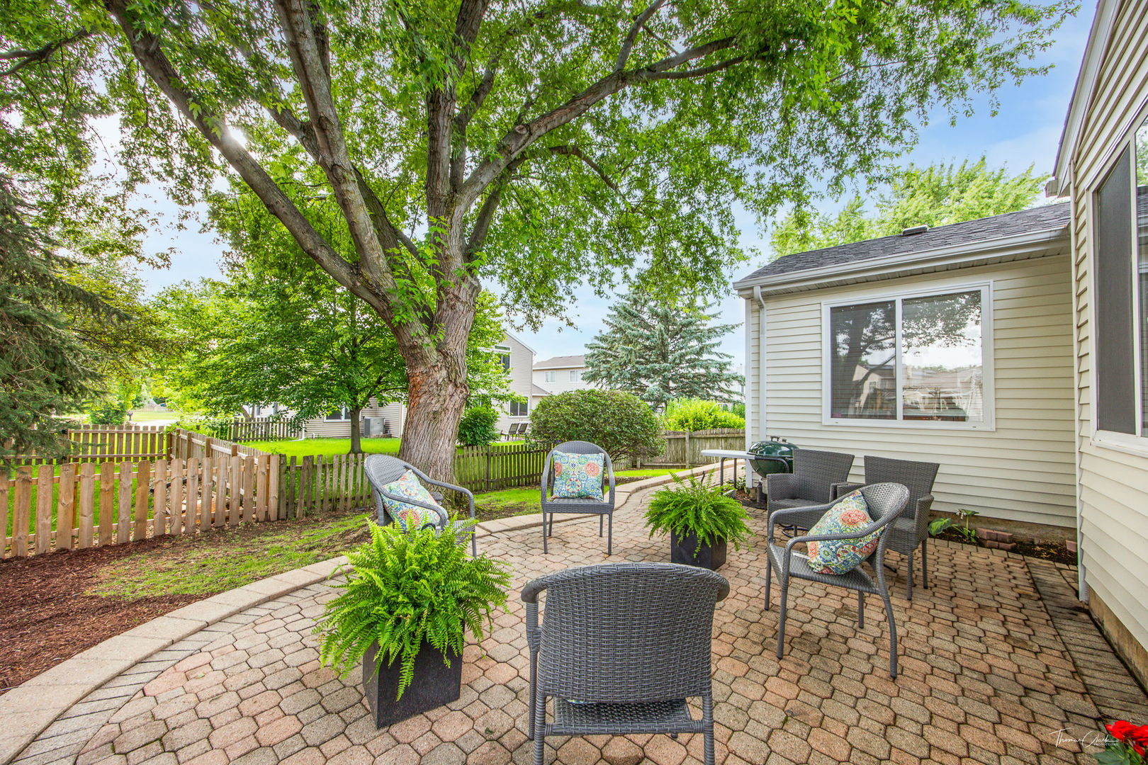 1910 Baldwin Way Bolingbrook, IL 60490 - Photo 33 of 38 a view of a patio with table and chairs and wooden fence