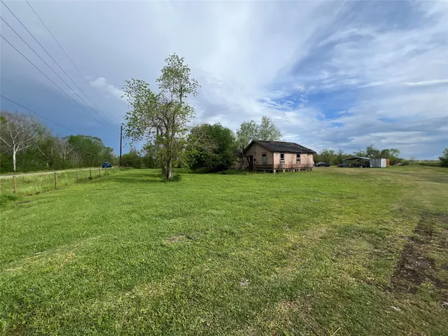 a view of a field of grass and trees