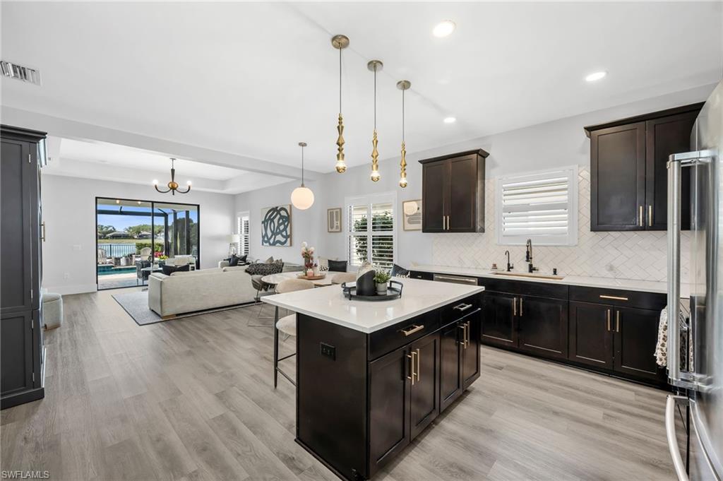 3634 Canopy Circle Naples, FL 34120 - Photo 5 of 20 Kitchen Featuring an Island. Open to The Dining Area and Living Room