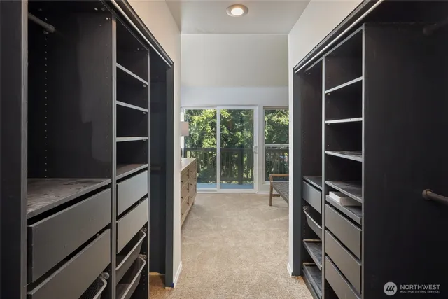 a view of walk in closet with empty racks