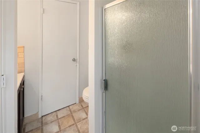 a bathroom with a granite countertop shower and a sink