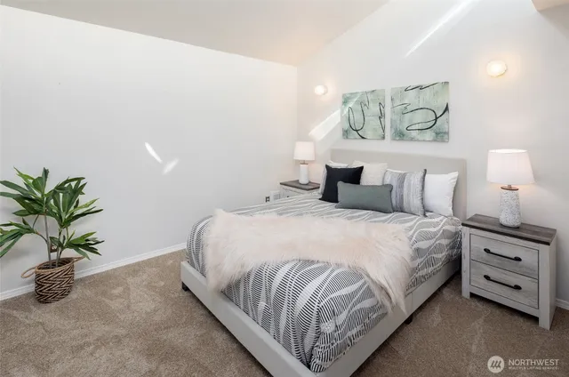 a bedroom with a bed and a potted plant