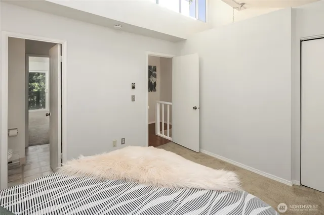 a bedroom with a bed and a mirror